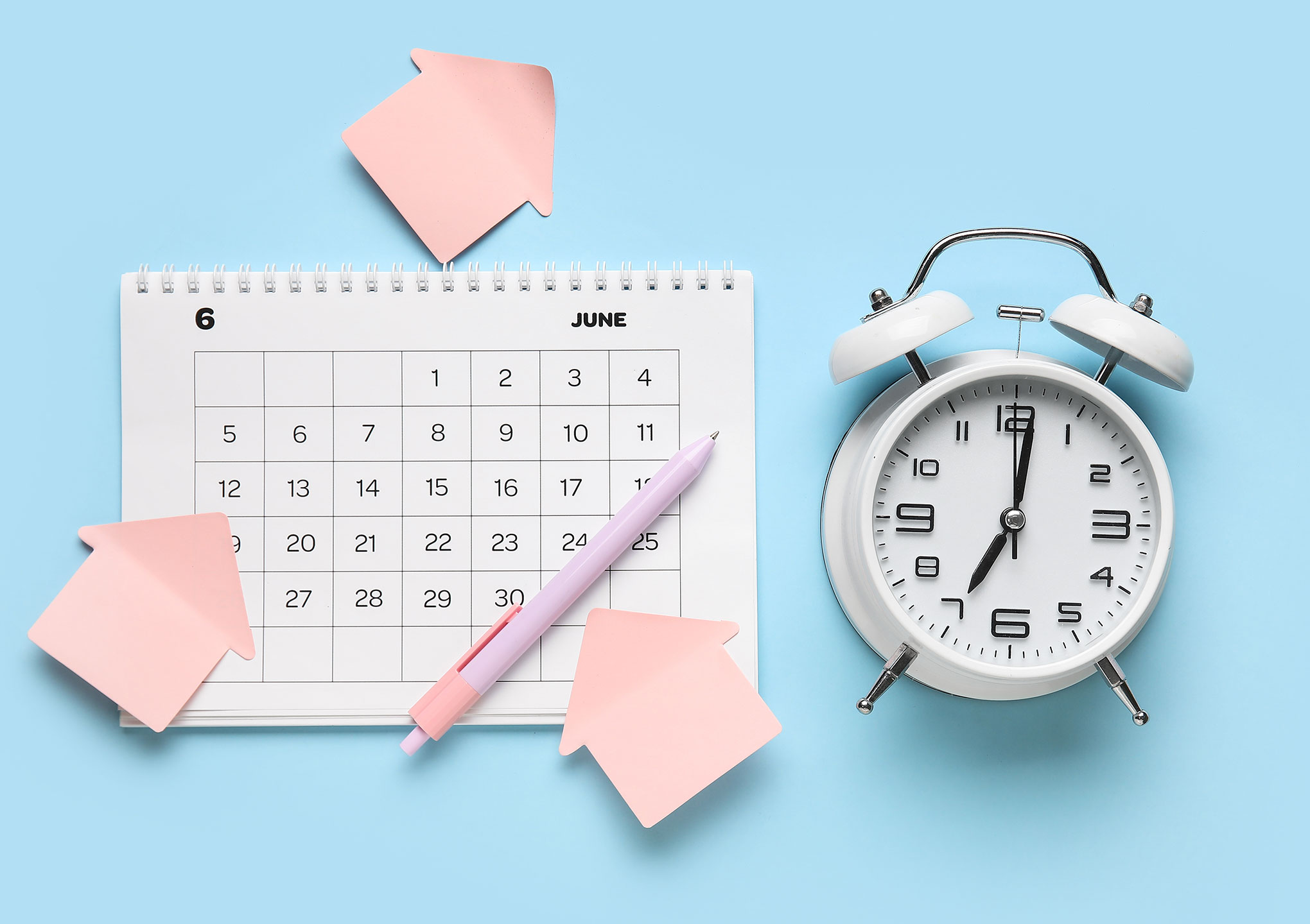 Calendar with alarm clock and office stationery on blue background